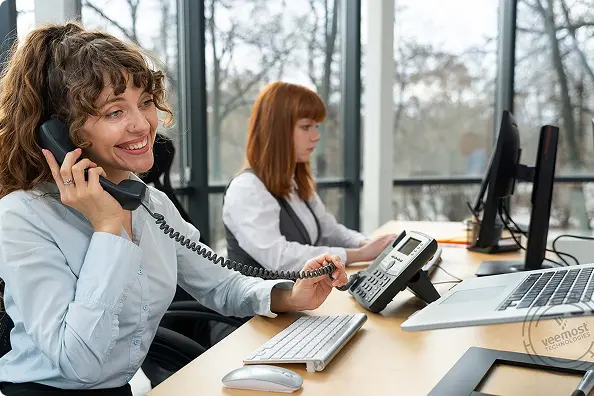 Women Working in call center at desk using VoIP