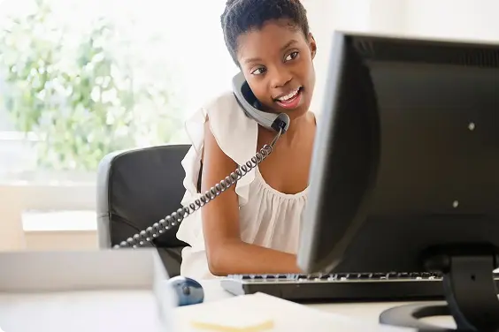 Women On A Desk Using Vonage VoIP phone
