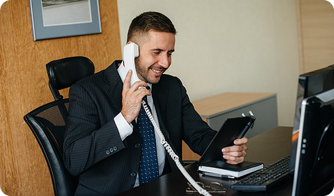 A person on a call with his good smiling sitting in office