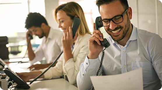 Male and female office workers on a business phone call